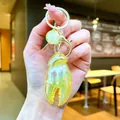 Vibrant iridescent yellow lobster claw keychain with pearlescent charm bag accessory. - Gold Hardware Electroplated Crab Claw / Aurora Yellow