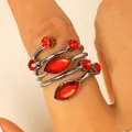 Elegant adjustable silver wrap ring with multiple faceted red rhinestones on model's finger - Ring (M-565)