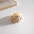 Detail showing the texture of a chunky cream resin ring with embedded rhinestones - Ring / Ivory