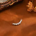 Close-up detail of curved silver copper pendant with sparkling waterdrop zirconia stones. - Seven-stone Pendant (T074) / Silver