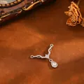 Detail view of a V-shaped copper pendant with a sparkling pear-cut zircon drop - Antler Water Drop Pendant (T074) / Silver