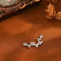 Detailed macro view of a curved silver copper pendant with sparkling zircon clusters - Irregular Stone Pendant (T074) / Silver