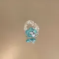Detail view of a glass bead ring with a turquoise resin flower and crystal center - Flower Shape / Blue