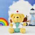 Close-up of a plush doctor teddy bear toy wearing a white medical lab coat and hat - Medical Bear / Height 14cm