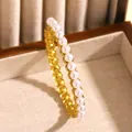 Vintage gold stainless steel bangle bracelet featuring elegant white pearl embellishment - White Artificial Pearl (10 Gold)