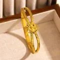 Vintage gold stainless steel sun bangle with textured finish in jewelry box. - Starlight Relief (14 Gold)