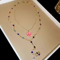 Detail view of gold necklace with rainbow crystal beads and a pink enamel flower pendant. - Pink Enamel Flower (Gold Chain) / Gold