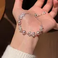 Elegant adjustable silver bracelet featuring white pearls and zircon bow charms. - 4# Bowknot Zirconia Pearl Adjustable Bracelet / Silver-Pink