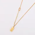 Detailed shot of 18k gold plated stainless steel necklace with gold bar pendant - Gold