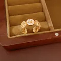 Detailed macro view of 18K real gold plated zircon starburst open ring in vintage box - Gold