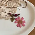 Detail view of preserved flower necklace with purple wood beads and rabbit charm - Purple Preserved Flower Rabbit Style (34#) / Purple