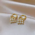 Detailed macro view of French vintage pearl earrings with crystals on champagne satin. - Hollow Cluster Pearl / Gold