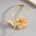 Detailed view of luxury gold crumpled metallic flower choker necklace with branch texture - Gold