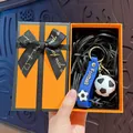 Cartoon soccer keychain in a premium orange gift box with a stylish black ribbon bow - Football / Orange Gift Box