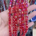 Close-up of faceted red cylindrical crystal glass beads for DIY jewelry making - Cylinder / Red AB
