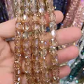Close-up of 8x9mm champagne faceted crystal cylinder beads for DIY jewelry making. - Cylinder / Amber Gold