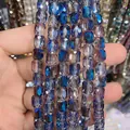 Macro view of 8x9mm faceted cylindrical iridescent blue glass crystal beads - Cylinder / Translucent Blue