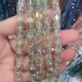 Close-up of 8x9mm iridescent faceted glass crystal beads for DIY jewelry making. - Cylinder / Spring Green