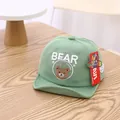Light green infant baseball cap featuring cute embroidered bear and text for sun protection - Embroidered Bear Green