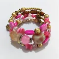 Detailed view of a vintage multilayer beaded wrap bracelet featuring pink stones and gold accents. - Pink