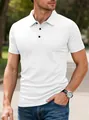 Close-up of white textured men's polo shirt featuring lapel collar and black buttons. - S / White