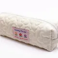Soft cream quilted flower pillow pencil case featuring a pink Lucky Flower patch - White