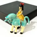 Artistic vintage enamel brooch featuring a girl riding a turquoise cow clothing accessory - Green Bull Girl Style (XH-706)