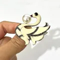 Elegant white swan brooch featuring shimmering crystals and a large decorative faux pearl. - White Swan Style (XH-1147)