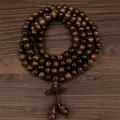 108 Vietnamese black rosewood prayer beads coiled on a rustic wooden surface - 8mm*108 Beads [Gourd Style]