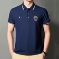 Detailed view of navy blue business polo shirt with premium chest embroidery - Navy Blue