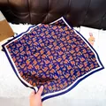 Blue square silk scarf featuring orange paisley pattern and decorative white border - New Silk 161 / 65