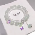 Elegant light green crystal bead bracelet with purple and green butterfly charms. - Double Butterfly Green