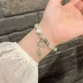 Elegant forest-style green crystal butterfly bracelet for women displayed on wrist - Bamboo Heart Bracelet (Green Bamboo)