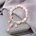 Forest style crystal bracelet with pink and white faceted beads and silver charms - Pink Lucky Cat