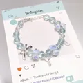 Elegant fairy forest style blue crystal bead bracelet featuring delicate flower and key charms - Ballet Rose Blue