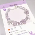 Dreamy purple crystal beaded bracelet featuring white floral and silver key charms - Ballet Rose Purple