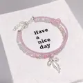 Handmade pink and white beaded double-layer bracelet featuring a silver bow charm - Ballet Style Bow Seed Bead Pink