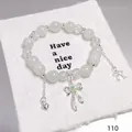 Forest style beaded bracelet featuring silver butterfly bow and heart charms on white card - Heart Bow Green