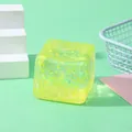 Macro view of a yellow glittery slow rebound water cube TPR stress relief squeeze toy - Yellow Glitter Cube