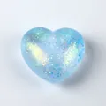 Detail shot of a blue heart-shaped squishy toy with sparkling glitter interior - OPP Bag / Blue