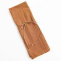 Folded orange cotton linen cloth napkin tied with rustic jute string bow - Orange