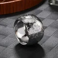 Close-up of silver metal napkin ring with engraved floral pattern for table decor. - Vintage Embossed Rose Style / Silver