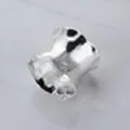 Creative hollow-out metal napkin ring in silver finish for dining table decor. - Irregular Wave Shape / Silver