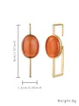 Minimalist gold stainless steel geometric earrings featuring oval orange cat's eye stones. - Asymmetric Orange Stone Style (E400-GO)