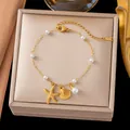 Elegant gold titanium steel bracelet with starfish shell charms and white pearls - Gold Starfish Shell Pearl Bracelet