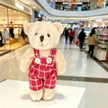 Adorable beige plush teddy bear charm wearing red plaid overalls displayed in a mall - Male Bear (Red and White Plaid) / 11cm