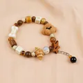 Handmade Jingdezhen ceramic beaded bracelet featuring cute poodle dog and bone charms in earth tones - Tangding Afternoon Tea Teddy and Bread (1789-01)