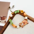Handmade Jingdezhen ceramic beaded bracelet featuring a cute bear holding a small fish - Yuyu Bala Bear Holding Fish (1798-02)