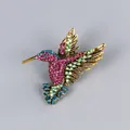 Vintage hummingbird brooch with vibrant colorful crystals on a golden base finish - Gradient Rhinestone Hummingbird Style (XD8997)