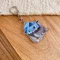 Cute blue shark acrylic keychain charm with funny character design on wooden surface - Silver-Biting Cat